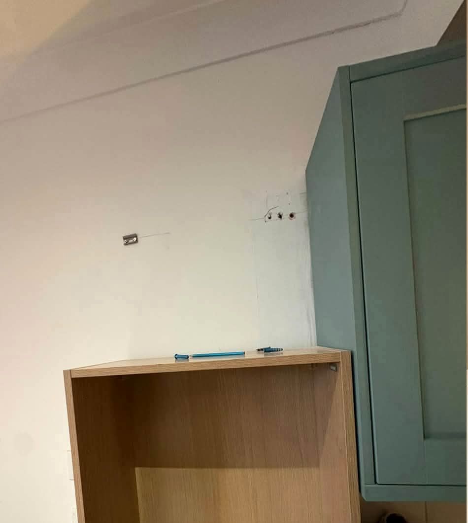 Bare kitchen wall with an unfitted cabinet carcass