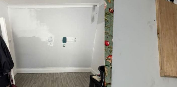 Plain white room with exposed fittings before wallpapering